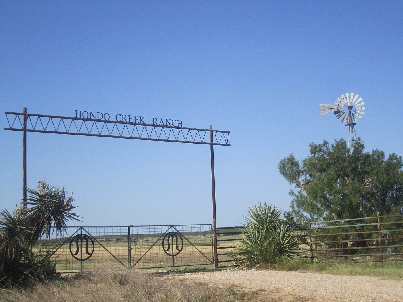 Pipe fence vs chain link — welded pipe fence line on a Texas ranch