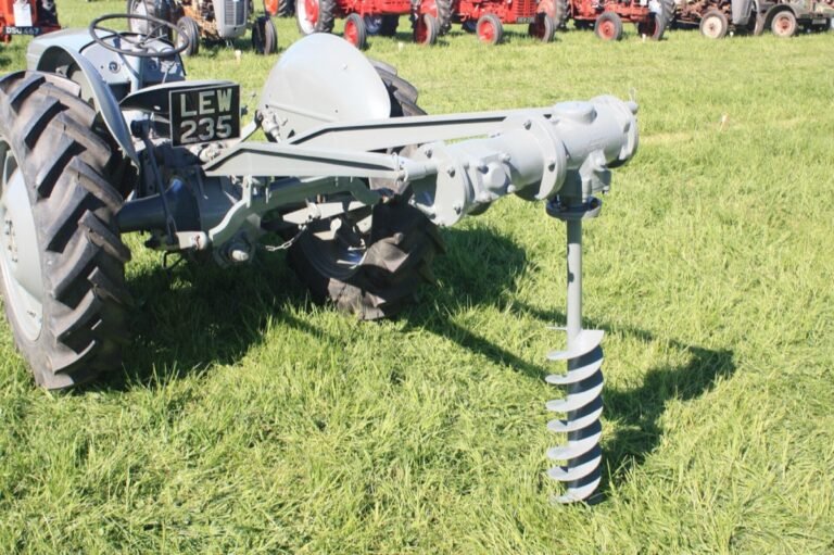 Post hole auger drilling fence post holes